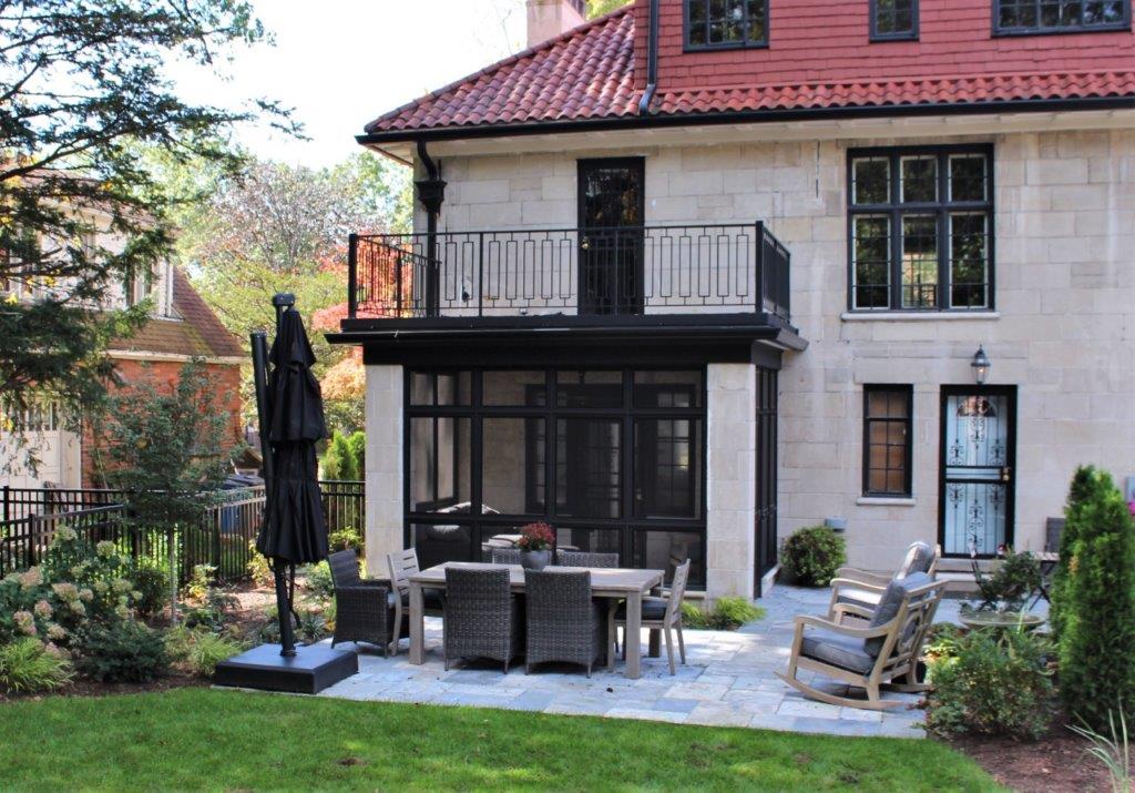Contemporary home exterior with metal balcony railings and custom gates